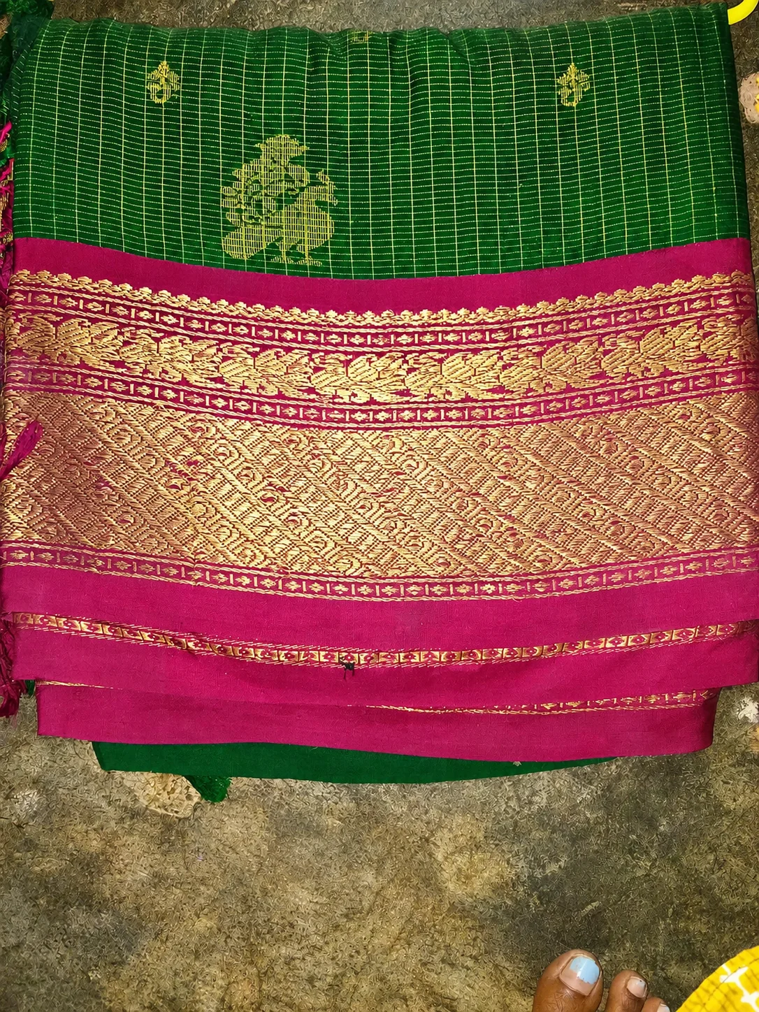 Old pattu saree buyers in Chennai — close-up of a green silk saree with rich gold zari border