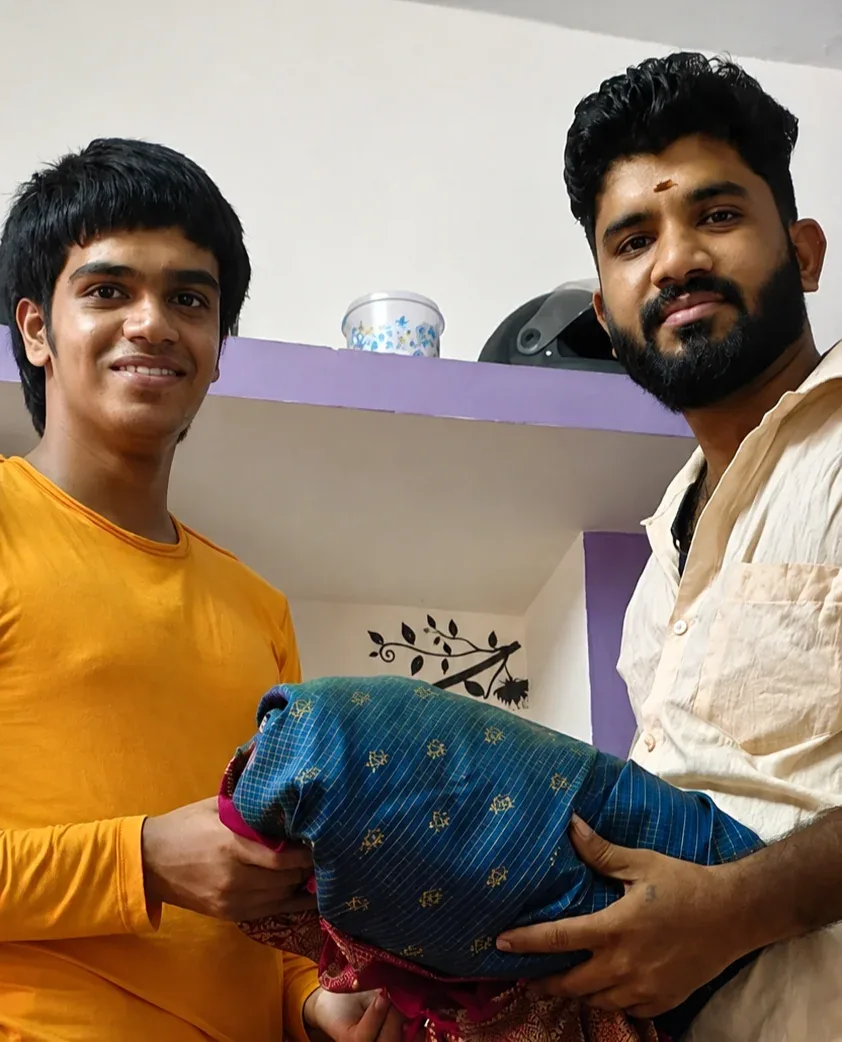 Second hand silk saree buyers Chennai — two customers handing over a blue and pink silk saree