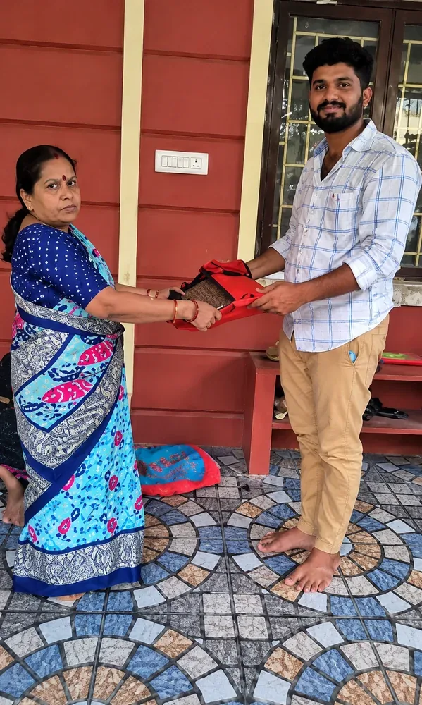 Old saree buyers near me — customer handing over a saree to our team at their doorstep