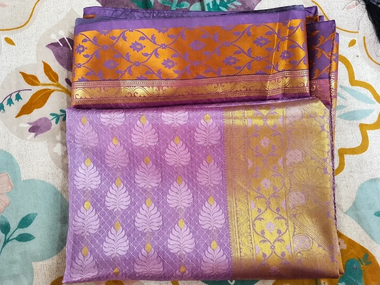 Old Kanchipuram silk saree buyers Chennai — folded purple and gold pattu saree