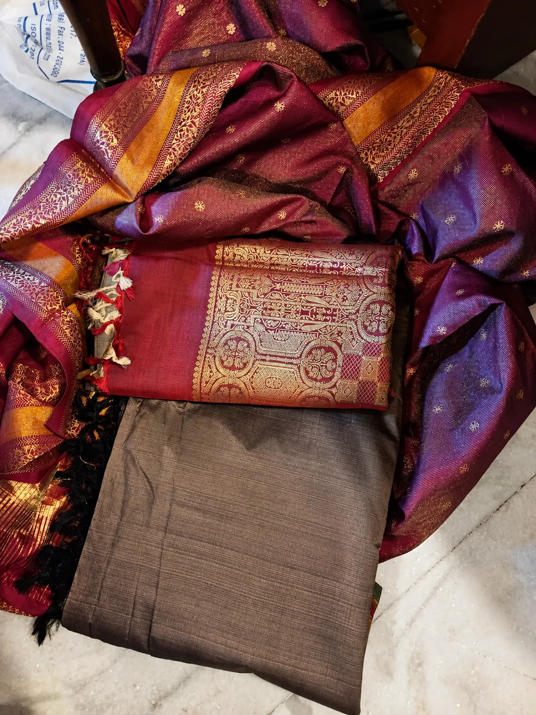 Cash for old silk sarees — maroon and purple silk sarees bundled for pickup